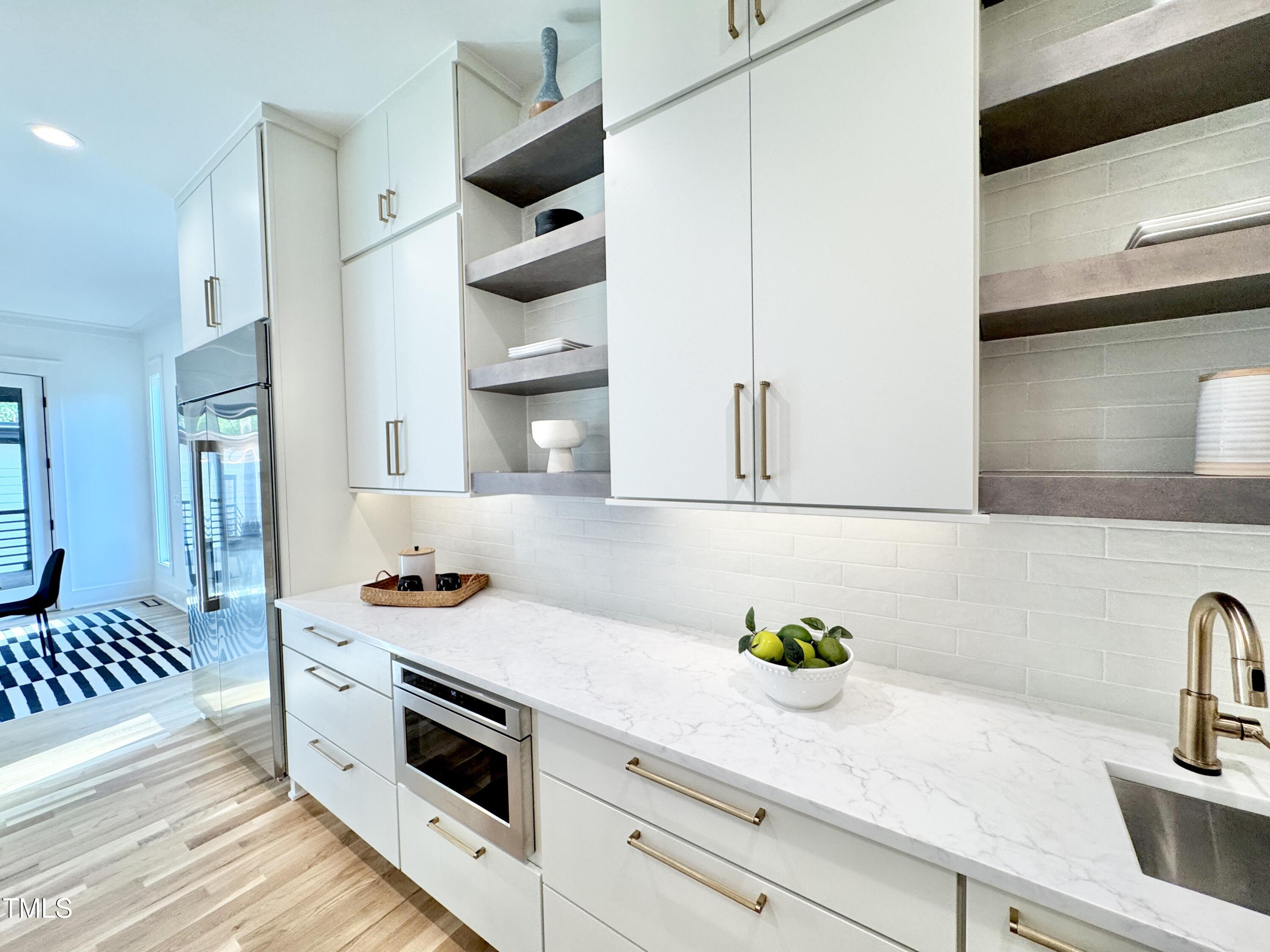 622 Glascock Street Raleigh, NC 27604 - Photo 26 of 81 a kitchen with stainless steel appliances a sink a stove and cabinets