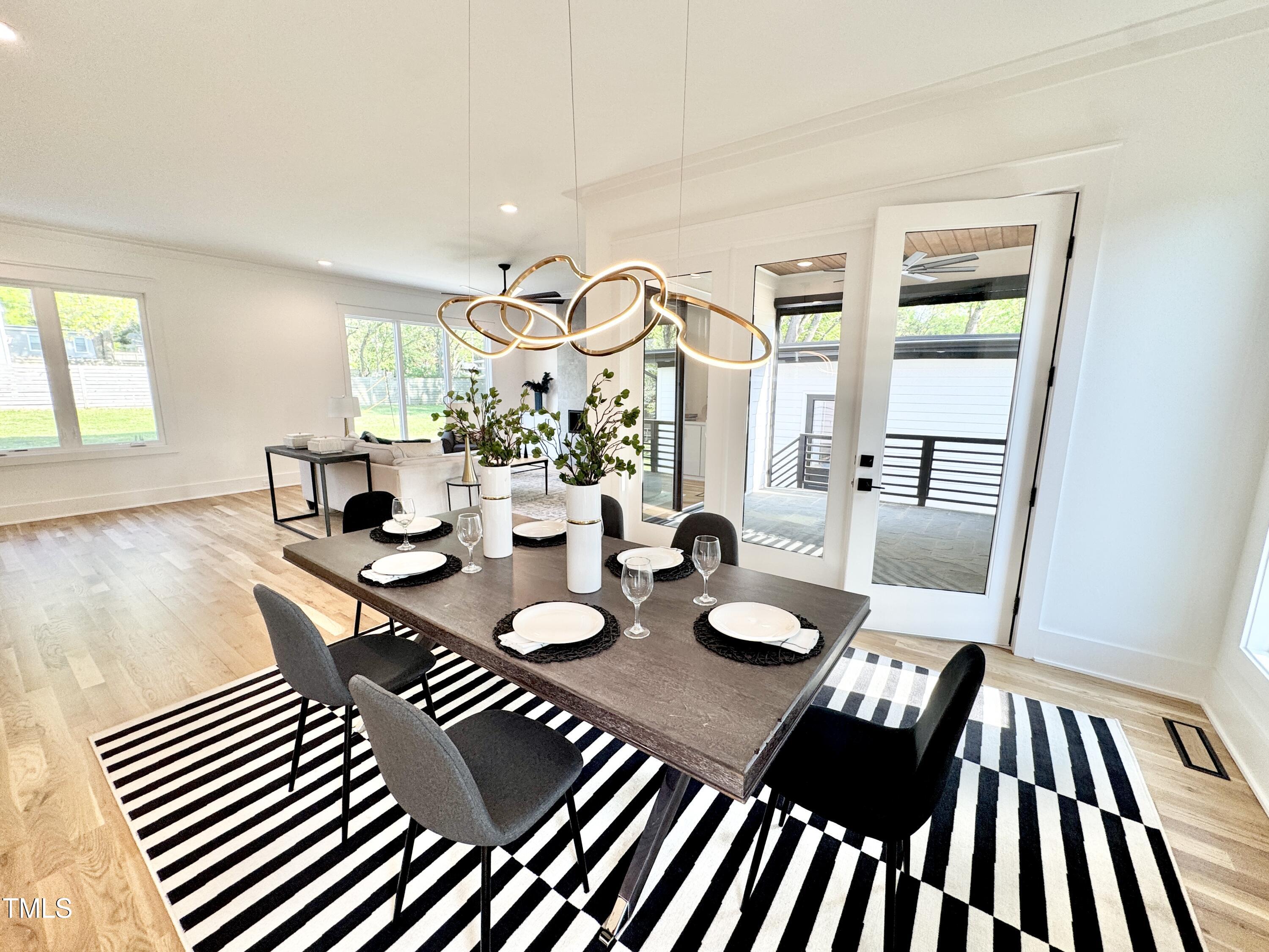 622 Glascock Street Raleigh, NC 27604 - Photo 28 of 81 a view of a dining room with furniture a chandelier and wooden floor