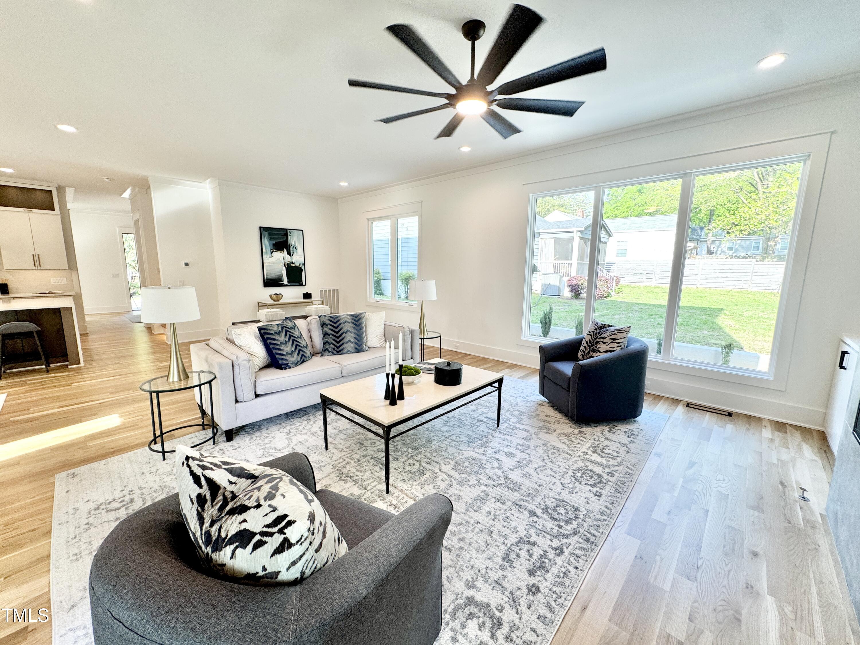 622 Glascock Street Raleigh, NC 27604 - Photo 32 of 81 a living room with furniture a rug and a large window