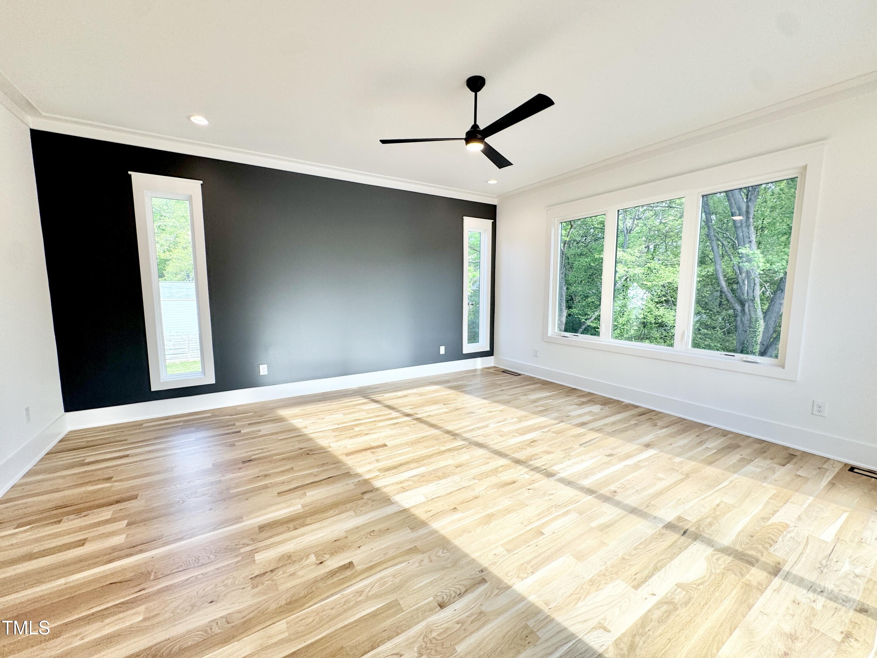 622 Glascock Street Raleigh, NC 27604 - Photo 49 of 81 a view of an empty room with wooden floor and a window