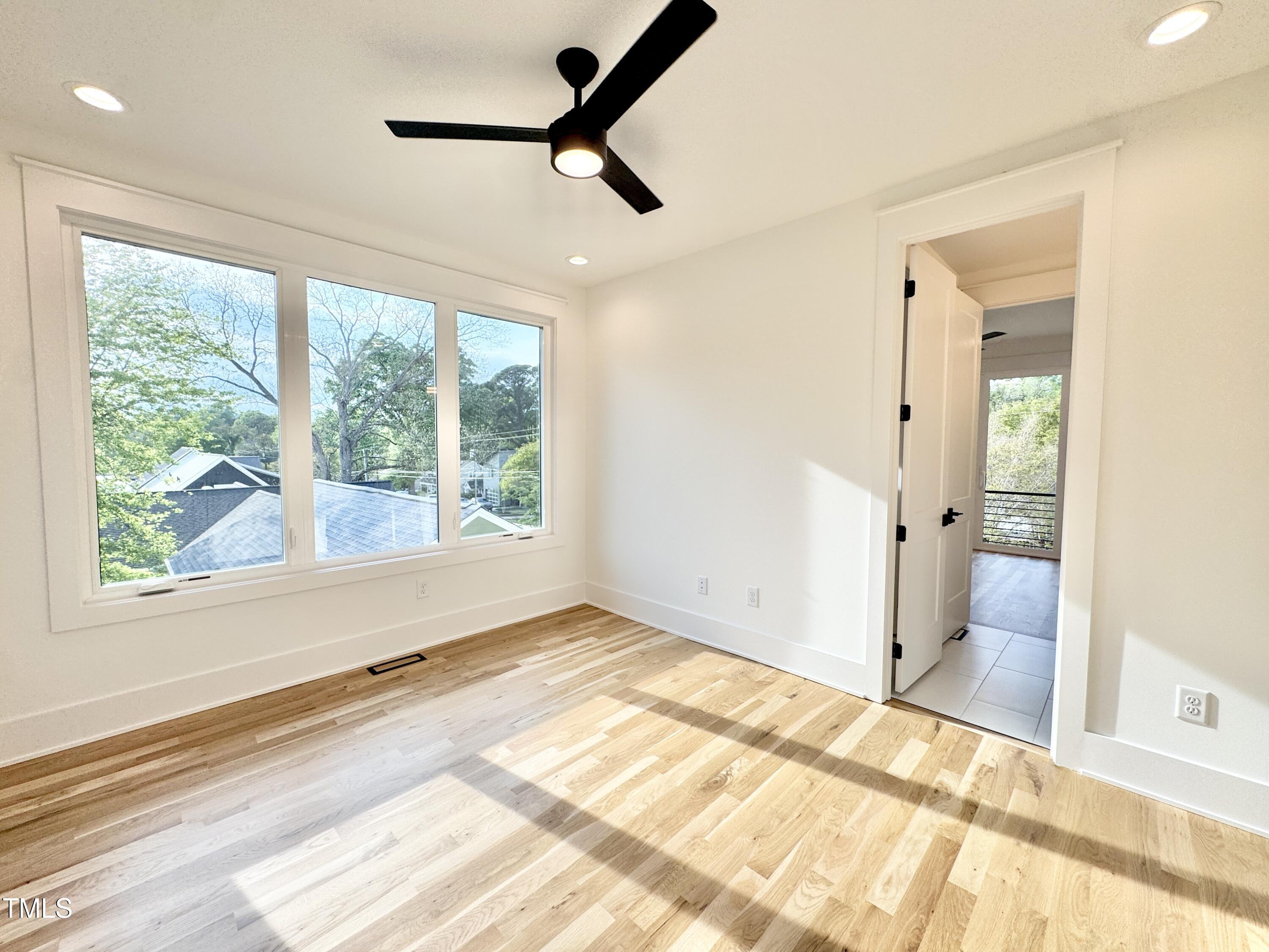 622 Glascock Street Raleigh, NC 27604 - Photo 63 of 81 a view of a room with a large bed and wooden floor