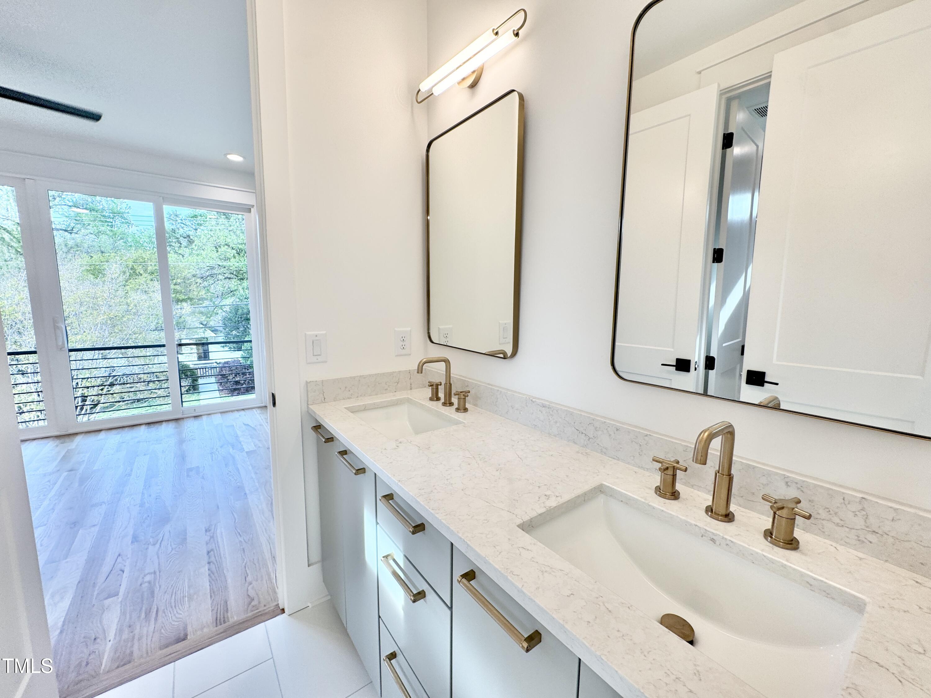 622 Glascock Street Raleigh, NC 27604 - Photo 65 of 81 a bathroom with a double vanity sink and mirror