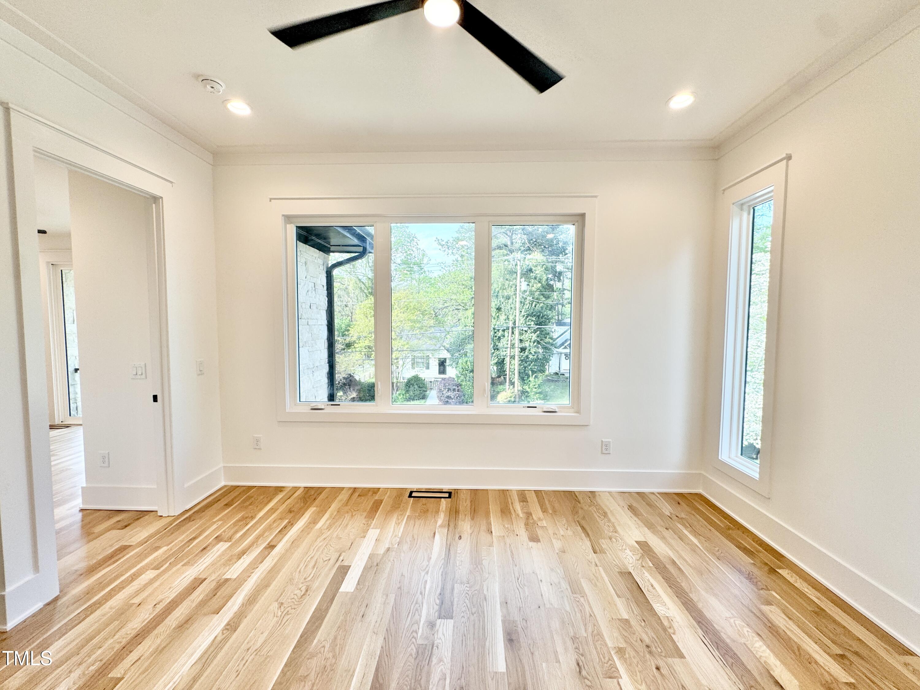 622 Glascock Street Raleigh, NC 27604 - Photo 66 of 81 an empty room with wooden floor and windows