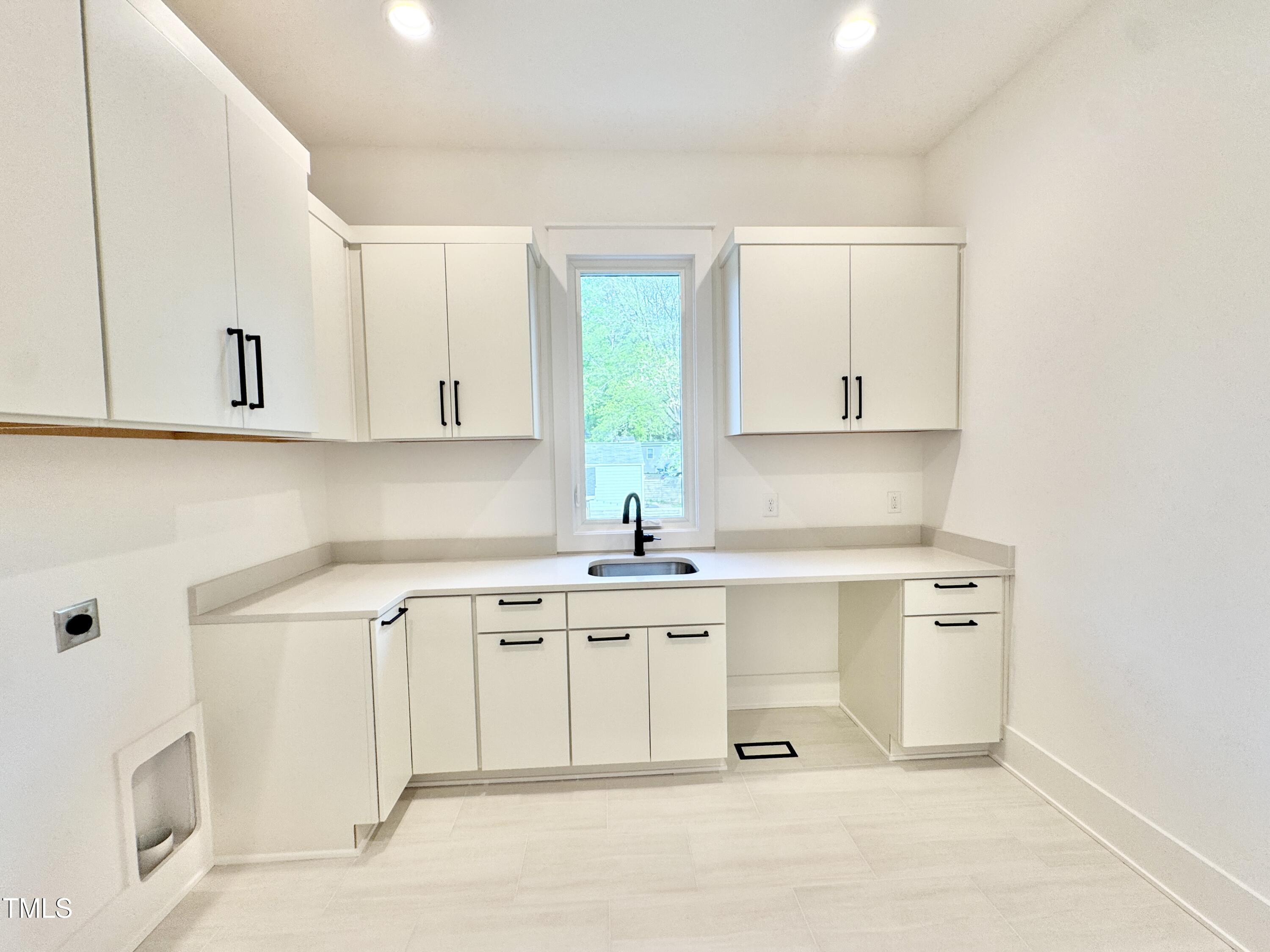 622 Glascock Street Raleigh, NC 27604 - Photo 70 of 81 a kitchen with stainless steel appliances granite countertop a stove a sink and white cabinets
