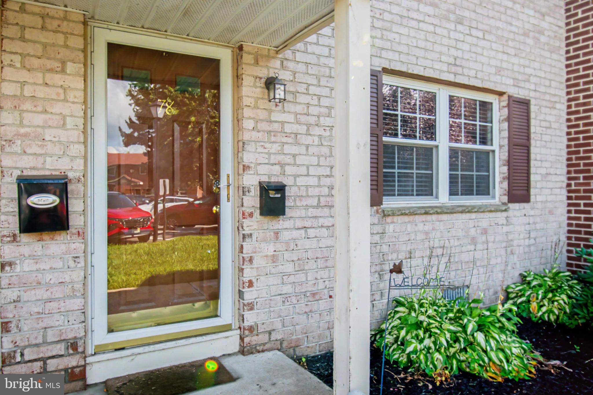 78 Forge Road Medford, NJ 08055 - Photo 1 of 28 Charming brick facade with lush greenery.