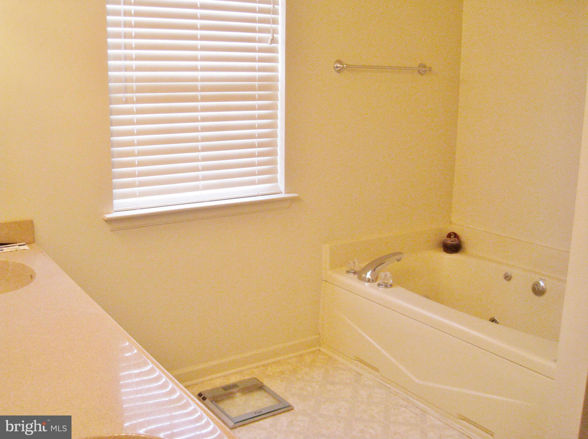 1901 Mitchellville Road Bowie, MD 20716 - Photo 19 of 20 a bathroom with a tub and a shower