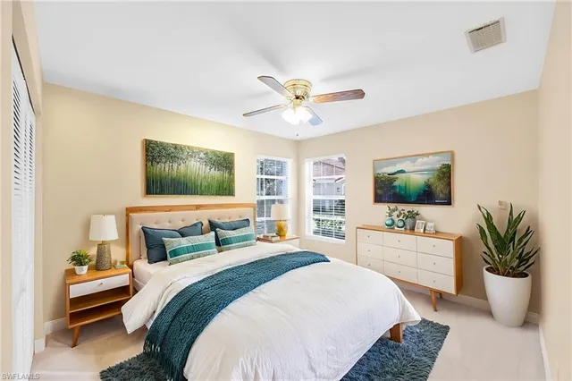 a bedroom with a balcony a bed and a chandelier