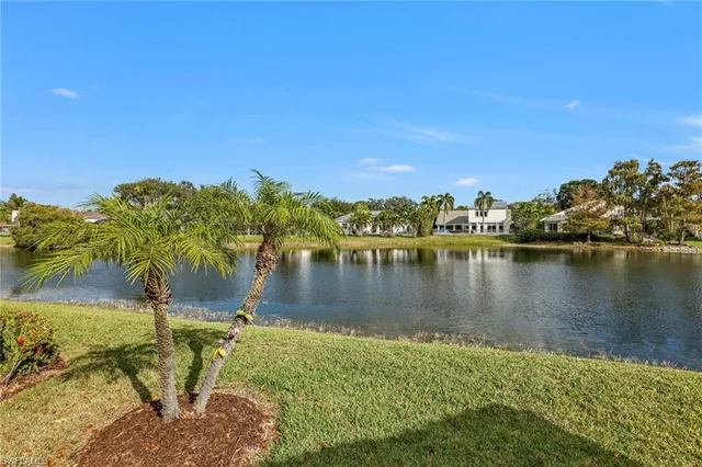 a view of a lake with houses in the back