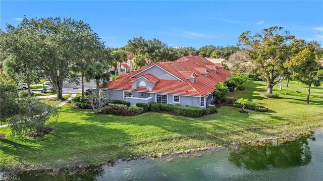 a aerial view of house with yard and green space