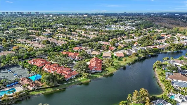 an aerial view of residential houses with outdoor space and swimming pool