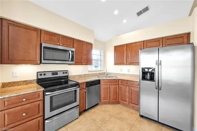 a kitchen with a refrigerator stove and microwave