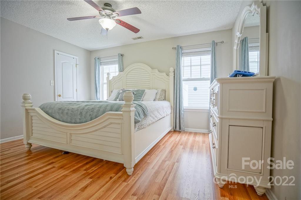 839 Matthews School Road Matthews, NC 28105 - Photo 16 of 37 a living room with a bed and a chandelier