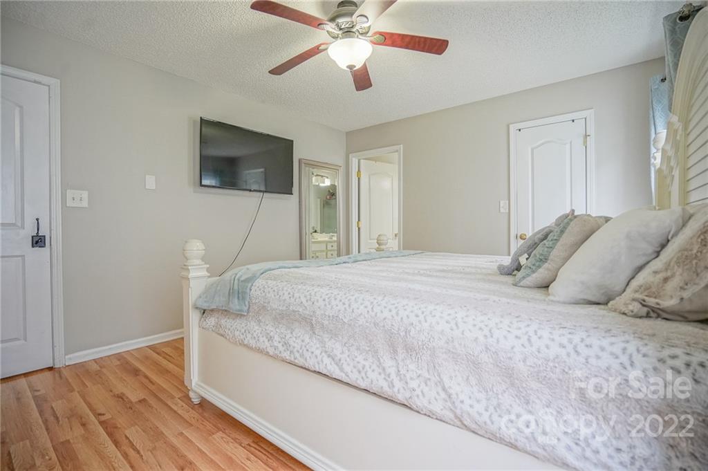839 Matthews School Road Matthews, NC 28105 - Photo 18 of 37 a bedroom with a bed and a flat screen tv