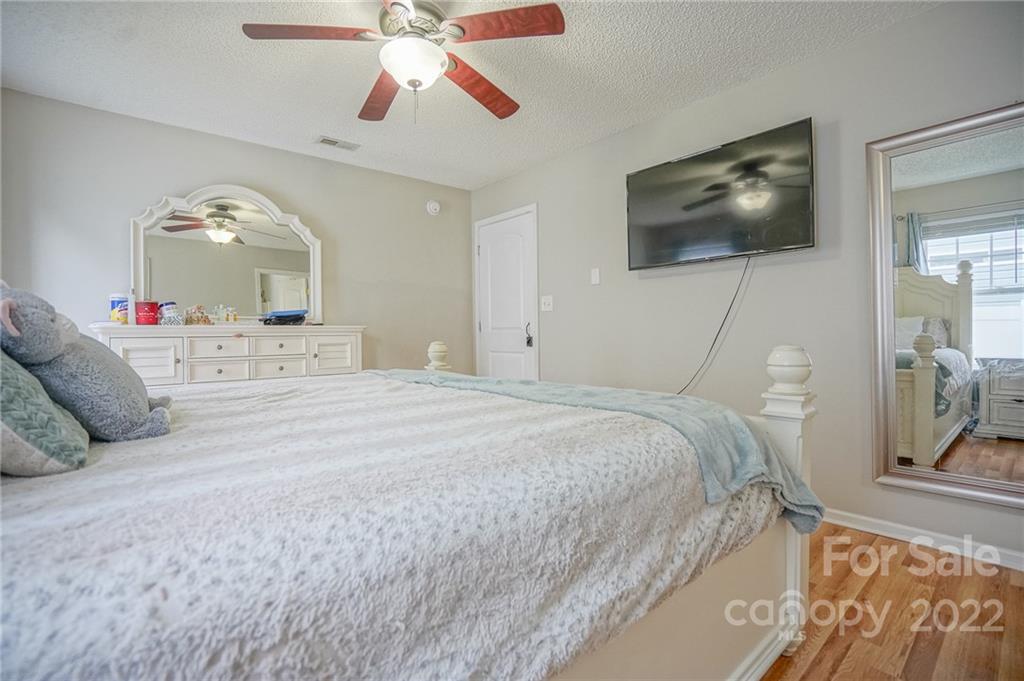 839 Matthews School Road Matthews, NC 28105 - Photo 19 of 37 a bedroom with a bed and a flat screen tv