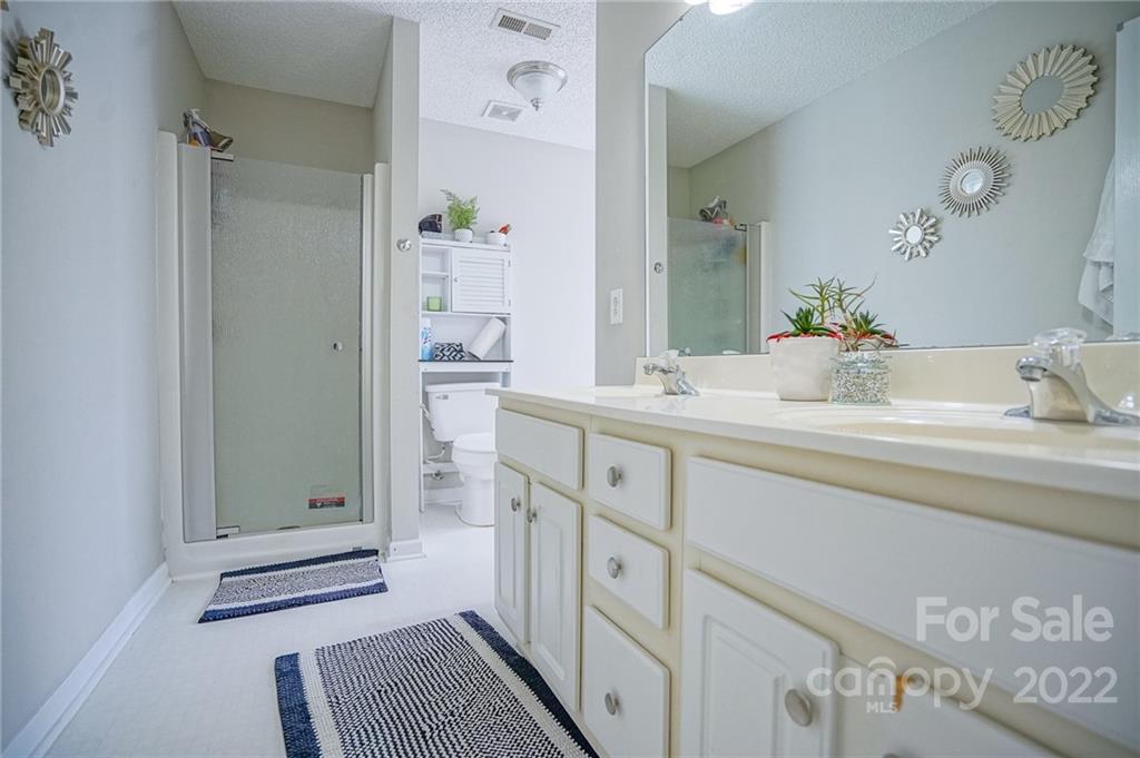 839 Matthews School Road Matthews, NC 28105 - Photo 20 of 37 a bathroom with a sink a mirror and a shower
