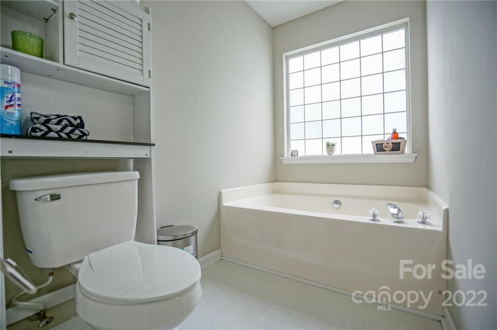 839 Matthews School Road Matthews, NC 28105 - Photo 21 of 37 a bathroom with a toilet a sink and a bathtub