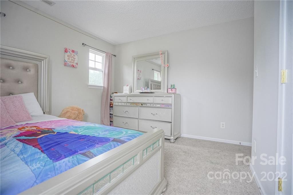 839 Matthews School Road Matthews, NC 28105 - Photo 24 of 37 a bedroom with a bed and a dresser
