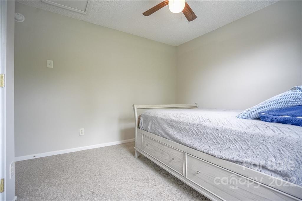 839 Matthews School Road Matthews, NC 28105 - Photo 27 of 37 a bedroom with a bed and a ceiling fan