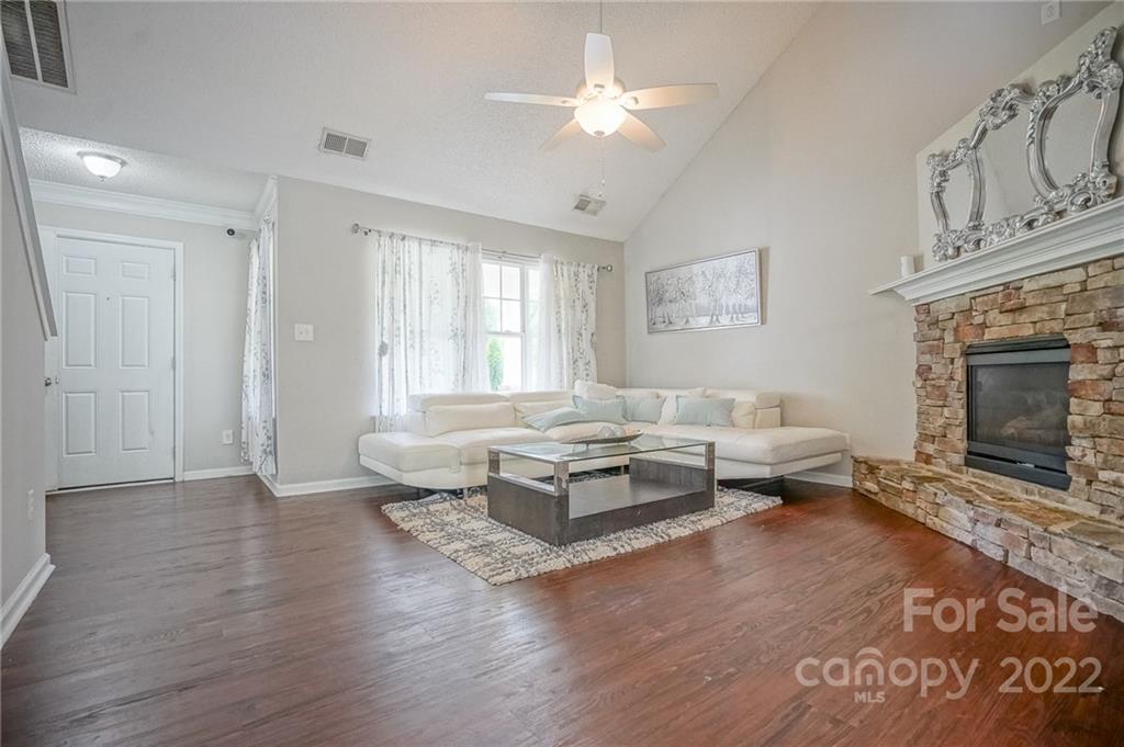 839 Matthews School Road Matthews, NC 28105 - Photo 6 of 37 a living room with furniture a fireplace and a rug