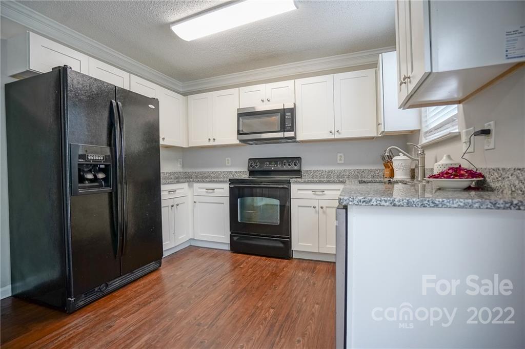 839 Matthews School Road Matthews, NC 28105 - Photo 10 of 37 a kitchen with stainless steel appliances granite countertop a refrigerator stove and sink