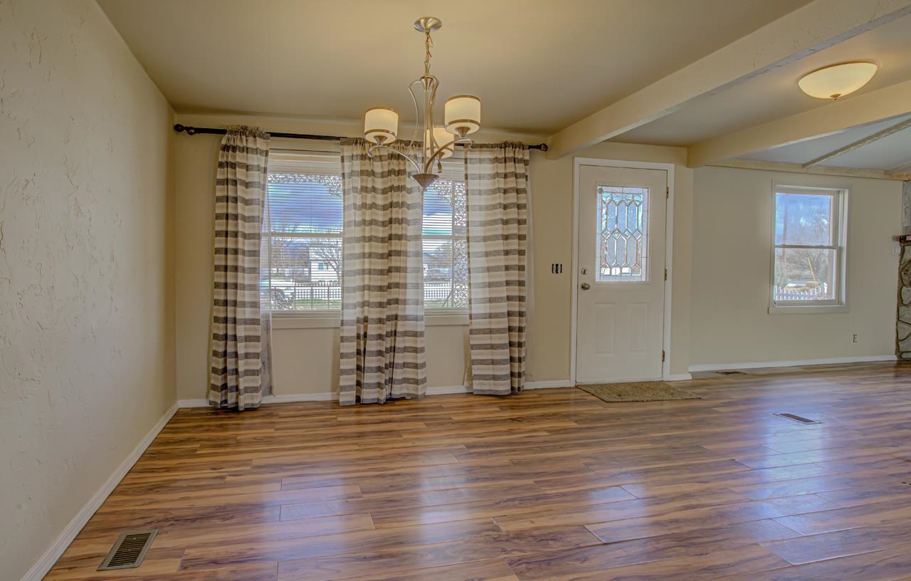 227 29 Road Grand Junction, CO 81503 - Photo 4 of 20 an empty room with wooden floor and windows