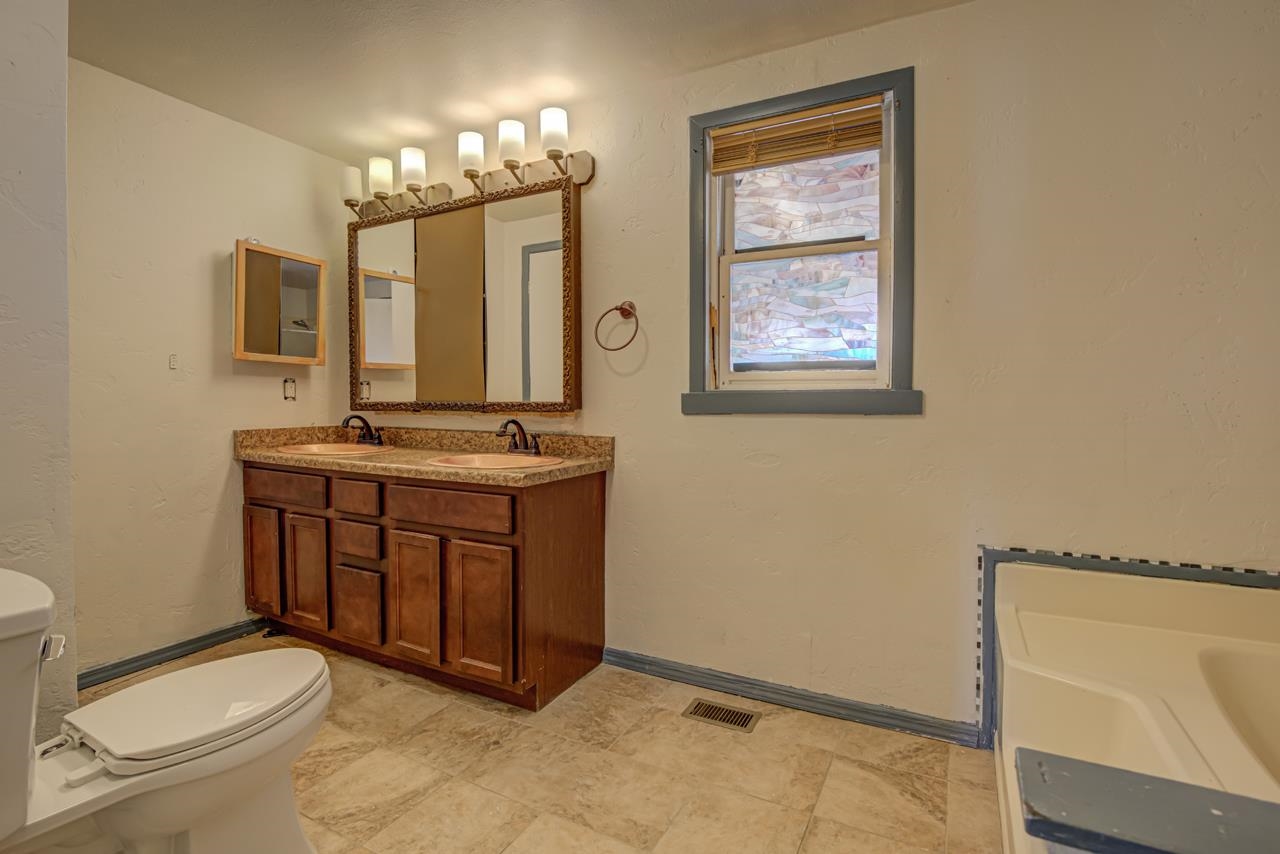 227 29 Road Grand Junction, CO 81503 - Photo 8 of 20 a view of spacious bathroom with a toilet sink and mirror
