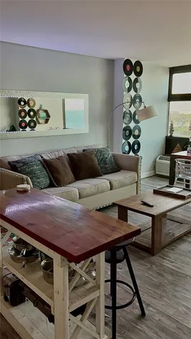 a living room with furniture and a mirror