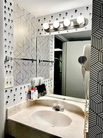 a bedroom with a white bed and cabinets