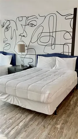 a bedroom with a bed a desk and chair