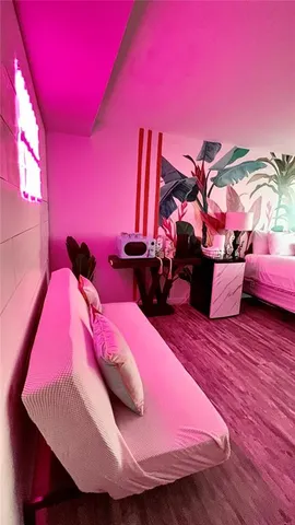 a view of a room with furniture and wooden floor