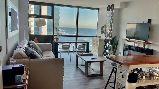 a room with a table chairs and a wooden floor