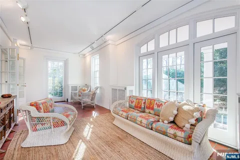 a living room with furniture and large windows