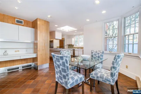 a dining room with furniture and a kitchen view