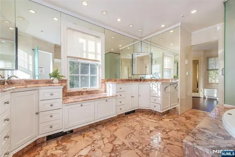 a spacious bathroom with a granite countertop tub sink and mirror