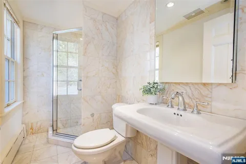 a spacious bedroom with a bed and a fireplace