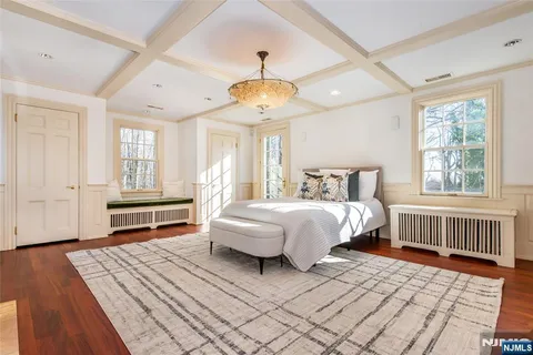 a spacious bedroom with a large bed and a fireplace