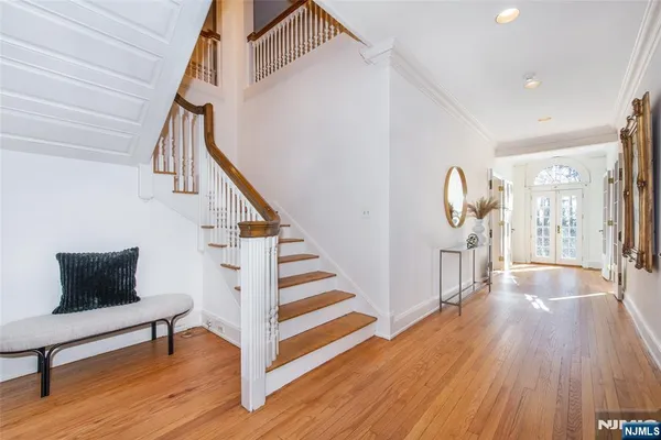 a view of entryway and hall with wooden floor