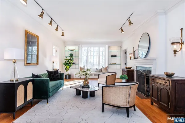 a living room with furniture a fireplace and a chandelier
