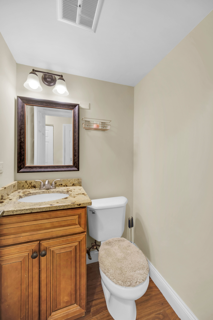 761 Colorado Court Carol Stream, IL 60188 - Photo 13 of 27 a bathroom with a toilet sink and mirror