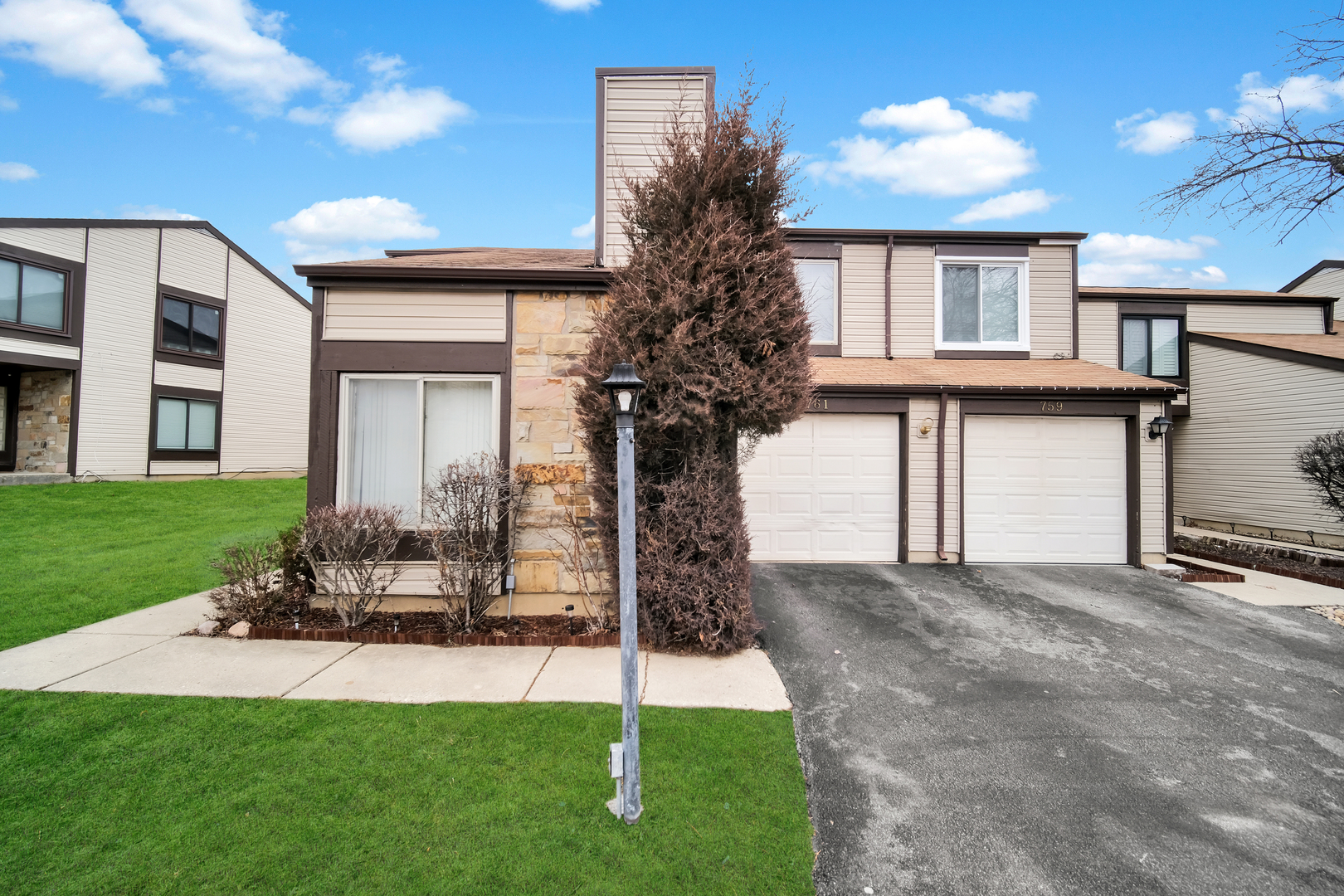 761 Colorado Court Carol Stream, IL 60188 - Photo 2 of 27 a front view of a house with a yard and garage