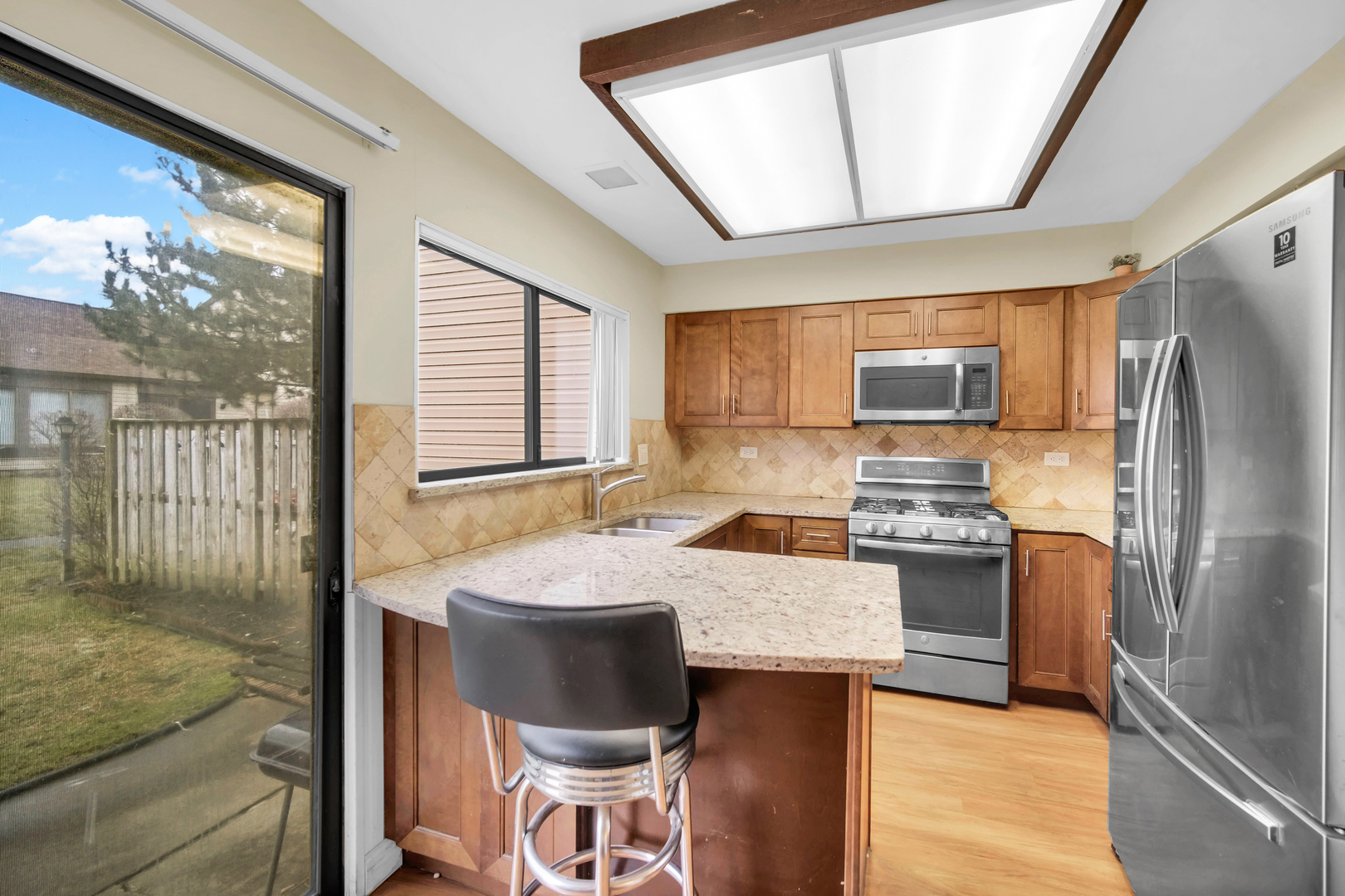 761 Colorado Court Carol Stream, IL 60188 - Photo 8 of 27 a kitchen with a refrigerator and a stove top oven