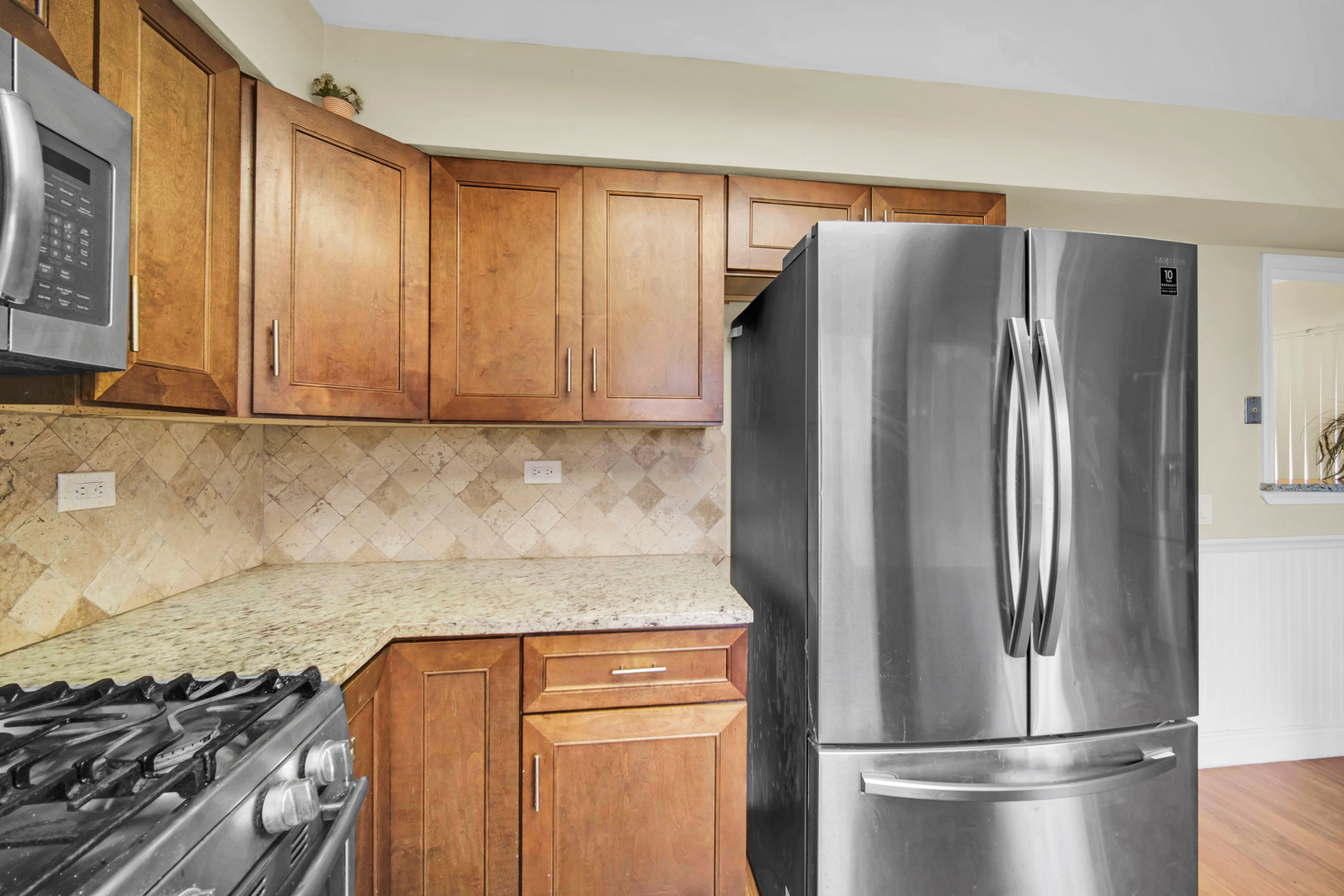 761 Colorado Court Carol Stream, IL 60188 - Photo 9 of 27 a metallic refrigerator freezer sitting in a kitchen