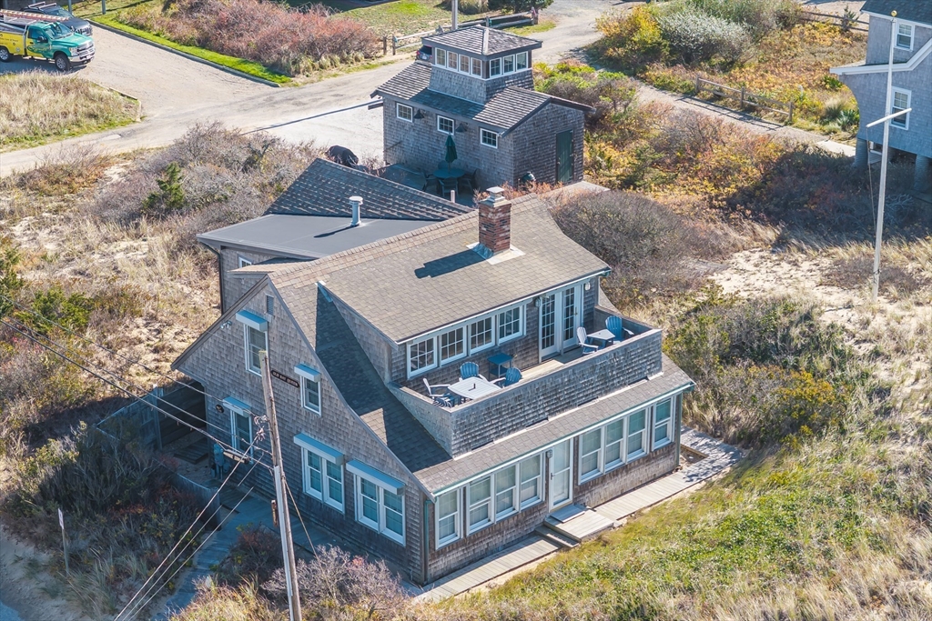 1145 Kingsbury Beach Road Eastham, MA 02642 - Photo 4 of 42 a view of a house with roof deck