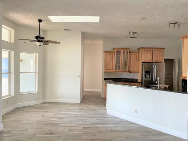 a view of a kitchen with a sink and a refrigerator