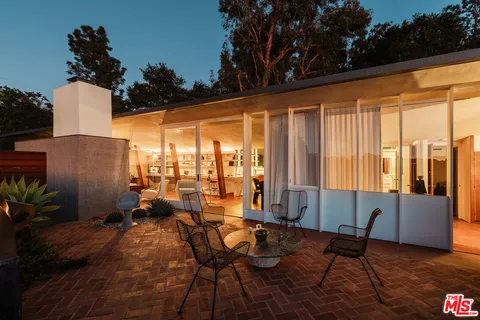 a living room with furniture and large windows