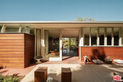 a view of a chairs and a table in the patio