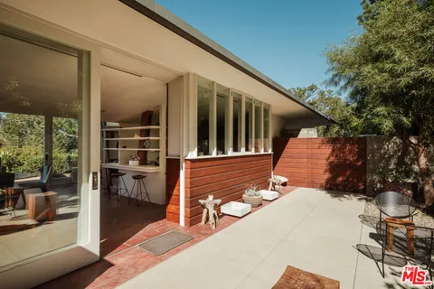 a view of balcony with two chairs and a table