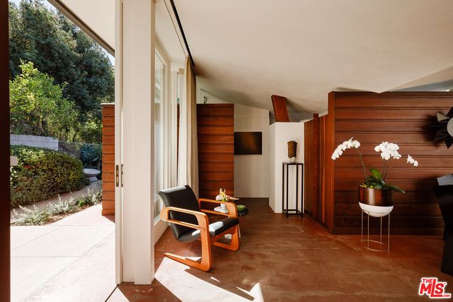 a view of a patio with table and chairs and potted plants