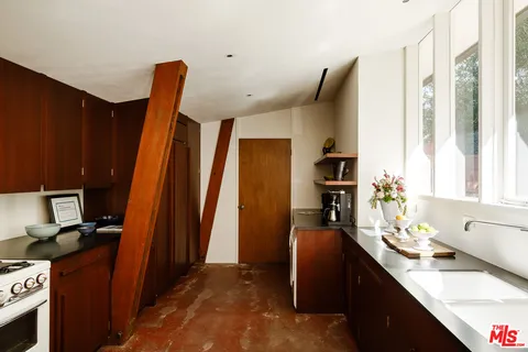 a hallway with a large window and furniture