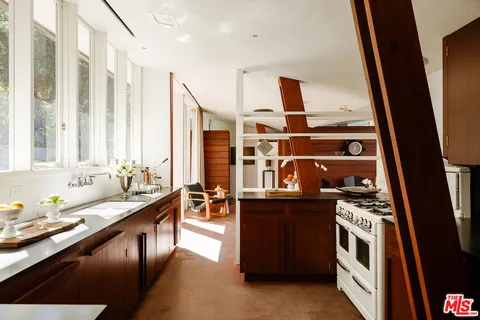 a kitchen with stainless steel appliances a stove and a sink